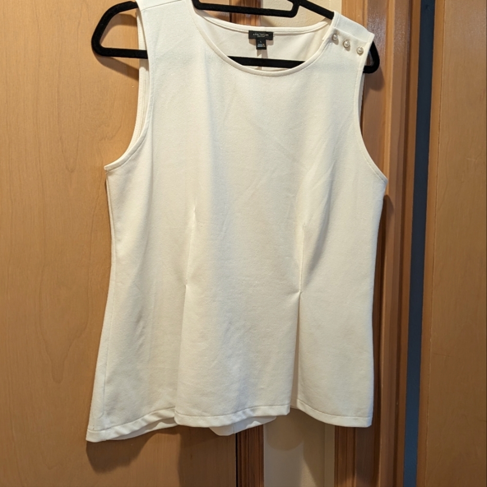 Ann Taylor, large cream sleeveless blouse with pearl buttons on one shoulder.